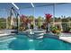 Beautiful screened pool with spa and a view of the golf course at 746 Fringed Orchid Trl, Venice, FL 34293