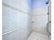 Walk-in shower with grab bars and tiled walls at 746 Fringed Orchid Trl, Venice, FL 34293