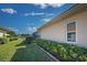 Landscaped side yard with hedges and a glimpse of the canal at 746 Fringed Orchid Trl, Venice, FL 34293