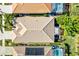 Overhead view of a house with a tile roof and a backyard at 121 Amora Ave, Venice, FL 34285