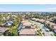 Aerial view of a residential neighborhood with houses and palm trees at 121 Amora Ave, Venice, FL 34285