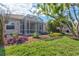 Spacious backyard with a screened patio, lush landscaping, and a relaxing atmosphere at 121 Amora Ave, Venice, FL 34285