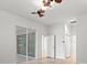 Bedroom with sliding glass doors and wood-look floors at 121 Amora Ave, Venice, FL 34285