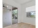 Bedroom with sliding doors to a screened patio at 121 Amora Ave, Venice, FL 34285