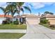 Single story home with two car garage and palm trees at 121 Amora Ave, Venice, FL 34285
