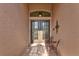 Double doors entry with a small sitting area outside at 121 Amora Ave, Venice, FL 34285