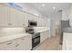 Modern kitchen with stainless steel appliances and light cabinetry at 121 Amora Ave, Venice, FL 34285