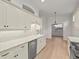 White kitchen features tile backsplash and stainless steel appliances at 121 Amora Ave, Venice, FL 34285