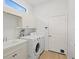 Laundry room with washer, dryer, and built-in cabinets at 121 Amora Ave, Venice, FL 34285