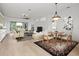 Open concept living and dining area with light flooring at 121 Amora Ave, Venice, FL 34285