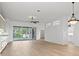 Spacious living room with sliding doors to patio and hardwood floors at 121 Amora Ave, Venice, FL 34285