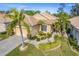 Single-story home with tile roof, landscaping, and two-car garage at 125 Amora Ave, Venice, FL 34285