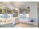 Bright bathroom with corner bathtub, double vanity, and large windows at 1307 Highland Greens Dr, Venice, FL 34285