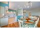Kitchen and dining area with hardwood floors and white cabinetry at 1307 Highland Greens Dr, Venice, FL 34285