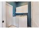 Laundry room with washer, dryer, and extra storage cabinets at 1307 Highland Greens Dr, Venice, FL 34285