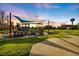 Sunset view of a community playground with play structures at 1307 Highland Greens Dr, Venice, FL 34285