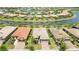 Aerial view showcasing homes with tile roofs and a community canal at 13510 Esposito St, Venice, FL 34293