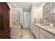 Elegant bathroom with double sinks, shower, and storage at 13510 Esposito St, Venice, FL 34293