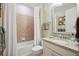 Clean bathroom with granite vanity, bathtub, and updated fixtures at 13510 Esposito St, Venice, FL 34293
