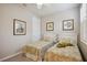 Welcoming bedroom with twin beds, plantation shutters, and nature artwork at 13510 Esposito St, Venice, FL 34293