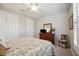Comfortable bedroom with a queen-size bed and dresser at 13510 Esposito St, Venice, FL 34293