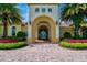 Community clubhouse with an arched entryway and Spanish-style architecture at 13510 Esposito St, Venice, FL 34293