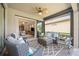 Relaxing enclosed patio with wicker furniture and view of backyard at 13510 Esposito St, Venice, FL 34293