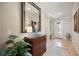 Bright entryway with decorative mirror, console table, and art at 13510 Esposito St, Venice, FL 34293