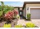 Welcoming walkway leading to front door, flanked by tropical plants at 13510 Esposito St, Venice, FL 34293