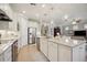 Modern kitchen featuring stainless steel appliances and white cabinetry at 13510 Esposito St, Venice, FL 34293