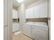 Convenient laundry room with washer, dryer, and cabinets at 13510 Esposito St, Venice, FL 34293
