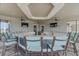 Outdoor kitchen and bar with granite countertops and blue chairs at 13510 Esposito St, Venice, FL 34293