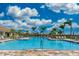 Large community pool with lounge chairs at 13510 Esposito St, Venice, FL 34293