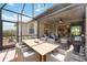 Outdoor dining space in a screened patio, overlooking the backyard at 13510 Esposito St, Venice, FL 34293