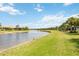 Serene water view with lush green landscape and homes at 13510 Esposito St, Venice, FL 34293