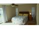 Main bedroom with ceiling fan, double bed and access to balcony at 1739 Bonitas Cir # 1724C, Venice, FL 34293