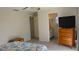 Bedroom with dresser, ensuite bathroom access, and closet at 1739 Bonitas Cir # 1724C, Venice, FL 34293
