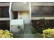 Condo entrance with stairs, showing landscaping and building details at 1739 Bonitas Cir # 1724C, Venice, FL 34293