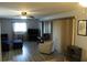 Living room with grey couch, ottoman, and access to a screened patio at 1739 Bonitas Cir # 1724C, Venice, FL 34293