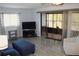 Living room with patio access, featuring a TV and comfortable seating at 1739 Bonitas Cir # 1724C, Venice, FL 34293