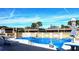 Community pool with lounge chairs and patio tables at 1739 Bonitas Cir # 1724C, Venice, FL 34293