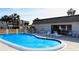 Community pool with lounge chairs and patio at 1739 Bonitas Cir # 1724C, Venice, FL 34293