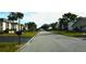 Residential street view with houses and palm trees at 1739 Bonitas Cir # 1724C, Venice, FL 34293