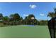 Outdoor basketball court with green surface and black fence at 21042 Anclote Ct, Venice, FL 34293