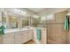 Spa-like bathroom with double vanity, shower, and tile flooring at 21042 Anclote Ct, Venice, FL 34293