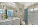 Clean bathroom with white vanity, shower, and toilet at 21042 Anclote Ct, Venice, FL 34293