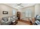 Cozy bedroom with sofa, wood floors, and large windows at 21042 Anclote Ct, Venice, FL 34293