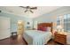 Bedroom with queen bed, wood floors, and access to the bathroom at 21042 Anclote Ct, Venice, FL 34293