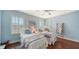 Bedroom with twin beds, hardwood floors, and plantation shutters at 21042 Anclote Ct, Venice, FL 34293