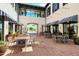 Relaxing community courtyard with tables, chairs, and striped awnings at 21042 Anclote Ct, Venice, FL 34293